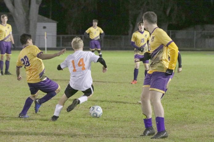  Leopard 38 and Bulldog 14 Christian Clemons simultaneously prepare to kick the ball during the Hernando home game against Zephyrhills.