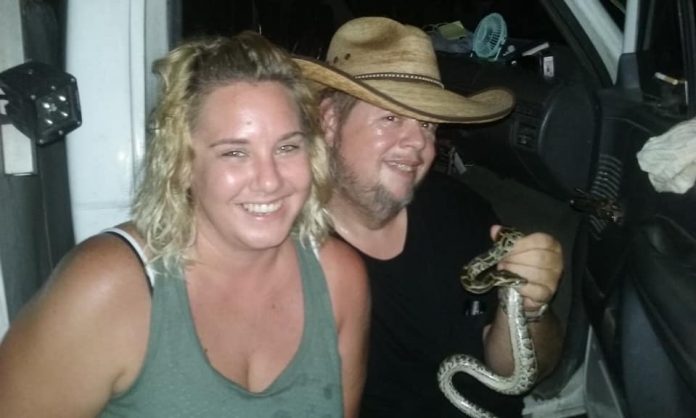 Toby and girlfriend Susan Shepherd with a hatchling Burmese python