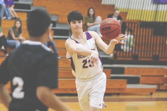 Hernando’s Jacob Lape passes the ball to his team mate during the Hernando Holiday Classic at Hernando High School.