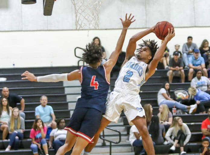 Nature Coast Tech Dedric Hall (2) goes up for a layup as Freedom’s Benard Reynolds (4) attempts to block his shot