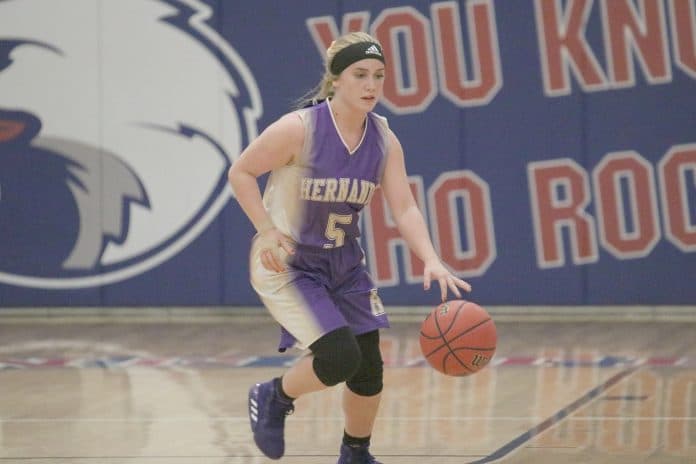 Hernando High’s Hayden Kimbrough dribbles the ball across the court. Photo by Betty Kolar. 