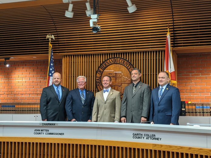 From left to right: outgoing chairman Jeff Holcomb, incoming second vice chairman Wayne Dukes, incoming chairman John Mitten, incoming vice chairman John Allocco and commissioner Steve Champion 