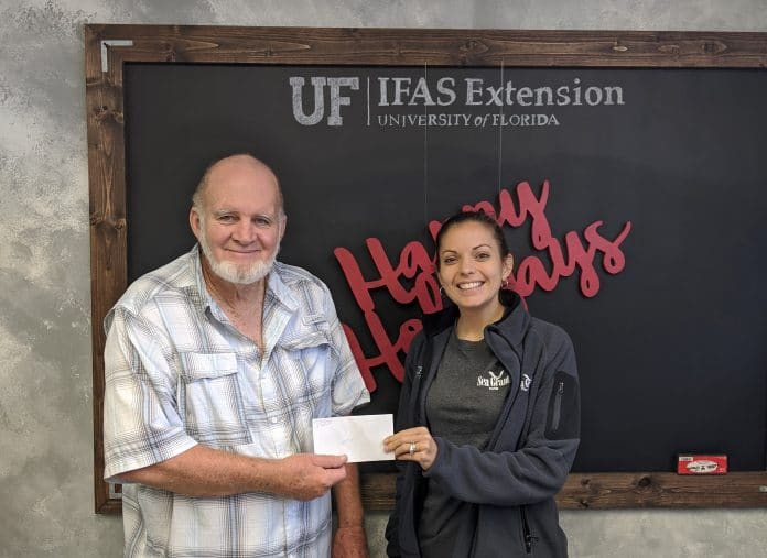 Chuck Morton, President of Hernando Environmental Land Protectors (HELP) presented Brittany Hall-Scharf, the Sea Grant Extension Agent in Hernando County, with a cheque for $2,000 to be used for shoreline restoration and enhancement at Jenkins Creek. Photo courtesy of Chuck Morton