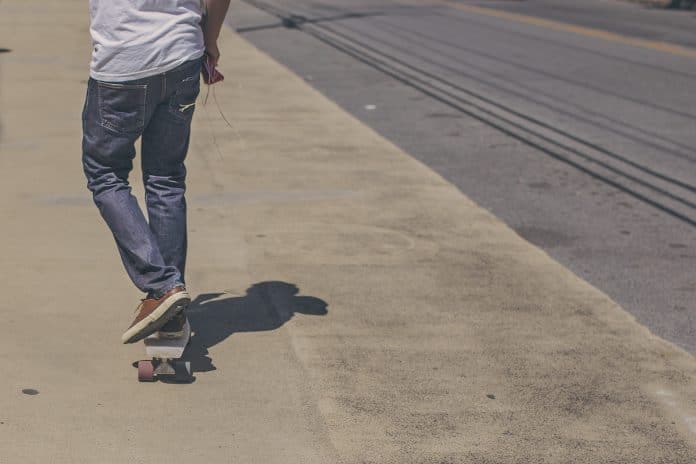 Skateboarder on sidewalk