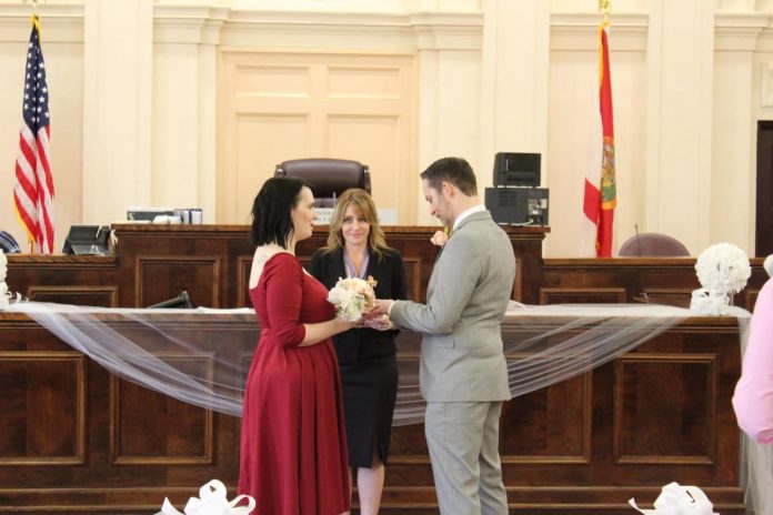 Judge Healis performs the marriage ceremony for Matthew Crowson and Sarah Englebert