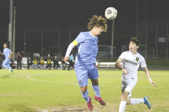 Sharks’ Thomas DiFrank (11) heading the ball during the Boys Soccer 4A District 6 Championship Tournament at Nature Coast Technical High School Friday Night.