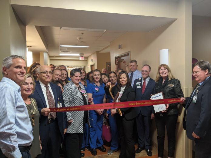 Director of the NICU, Raquel Ferreira, MSN, RNC-NIC cuts the Greater Hernando County Chamber of Commerce Ribbon surrounded by community leaders and the Oak Hill team.