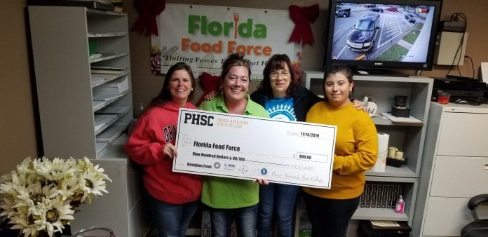 PHSC Social and Human Services Club presents a check to Florida Food Force. Photo by Bonnie Rogers  Pictured from left to right  is Bonnie Rogers, Rhonda Miller, Elaine Mentry and Amanda Soklaski. “This was an amazing day for us to present them a check after having an auction to raise the money,” said Rogers. Photo by