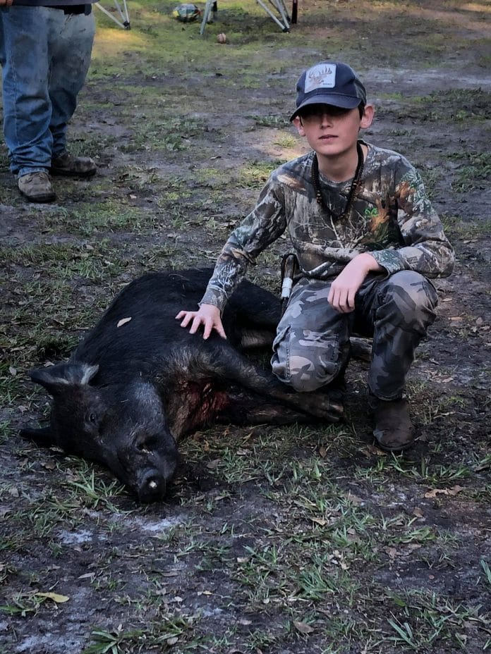 Thirteen year old Hunter Geer with his first ever wild boar taken with a Bowie style blade..jpg