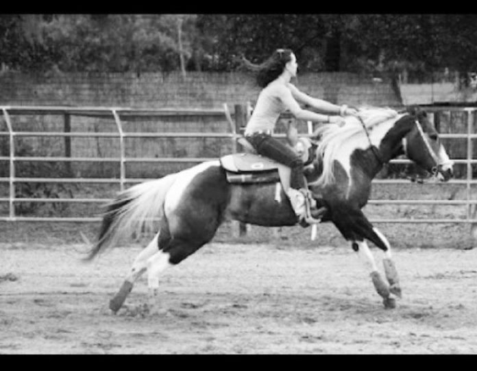 Toby's friend Tiffany riding the old mare Tickles, on a barrel pattern