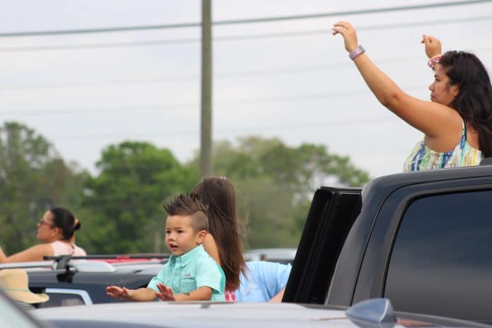 A young family worships from their pickup on Easter Sunday at Great LIfe Church. 