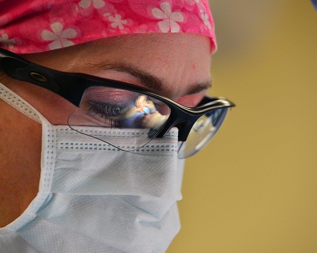 Medical professional wearing mask and eye protection