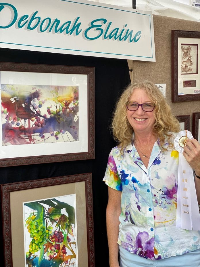 Deborah Elaine and her watercolor art.  Elaine won third place in the Fine Arts division at the Art in the Park Artshow this year.