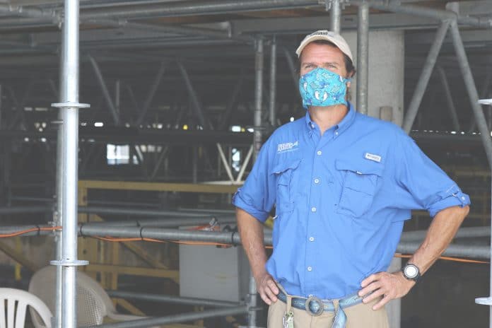 Eric Hovland, The Florida Aquarium Associate Curator seen here above the Coral Reef exhibit. This part of the aquarium is where the public can participate in the Shark Swim program. “We are here to help better engage people with sharks.” Photo by Alice Mary Herden