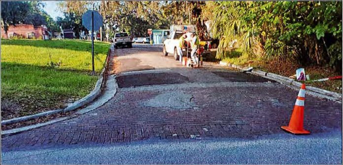 North Bailey Ave looking south, showing numerous asphalt repairs