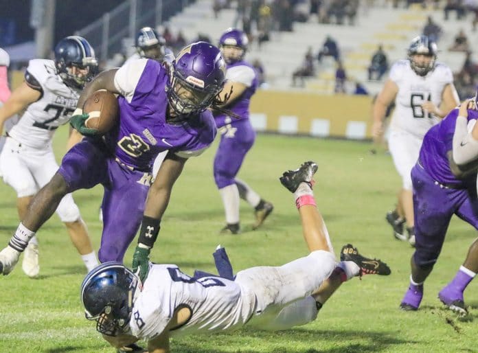 In 2019, Hernando’s Kev’on Williams (2) rushes after a handoff from quarterback Maurice Holland but is cut off by Central’s Tre Joyner (8).  FILE PHOTO by Alice Mary Herden.