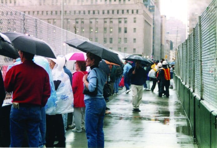 Onlookers at Ground Zero on a rainy day in June 2002. Photo by Rocco & Julie Maglio.