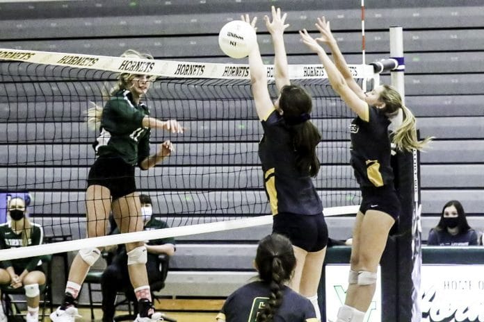 Monday night October 12, 2020 Girls Volleyball at Weeki Wachee. Hornet #11 KRISTEN PIZZANO slams it past Cypess Creek defenders.