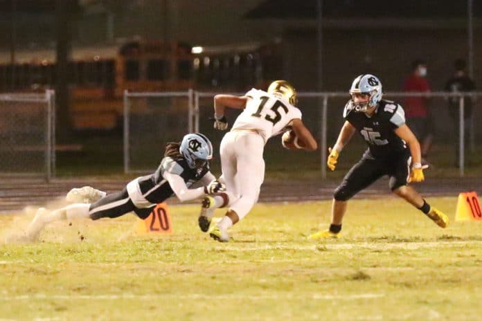 Friday night October 2, 2020 football Citrus vs Nature Coast. Shark #1 Fabreyon Burnett goes low and Shark #15 going high to take down Hurricane  #15 Gabe Robie.  Photo by CHERYL CLANTON.