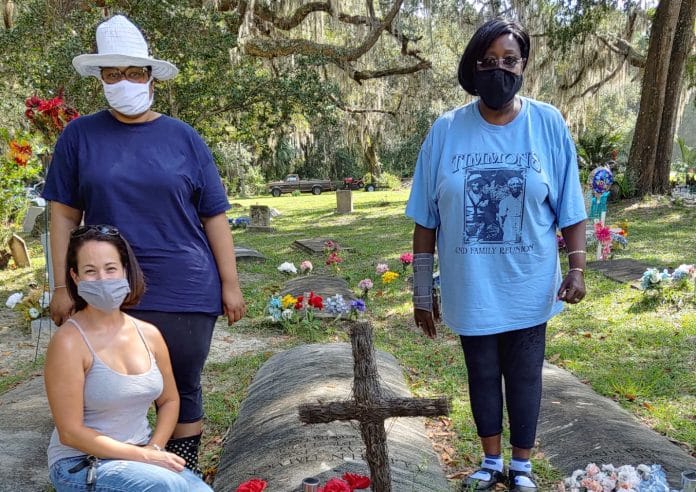 Christina Ottersbach, Gina Hall, Viennessee Timmons Black beside the grave of Ms. Black's father