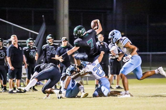 Friday night November 6, 2020 Nature Coast steps on the field of the Weeki Wachee Hornets. Hornets QB #7 Sr Kobe Bigger runs the ball to get a first down for Weeki Wachee against the Sharks.