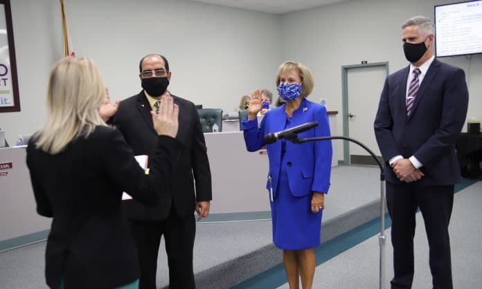 Judge Kristie M. Healis swearing in newly re-elected school board members, Gus Guadagnino and Linda Prescott, with School Superintendent, John Stratton.  