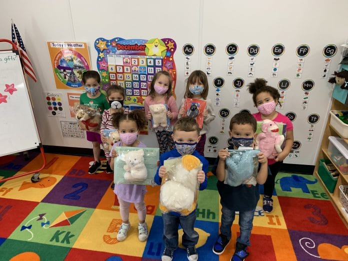 Kids with their books and reading buddies 