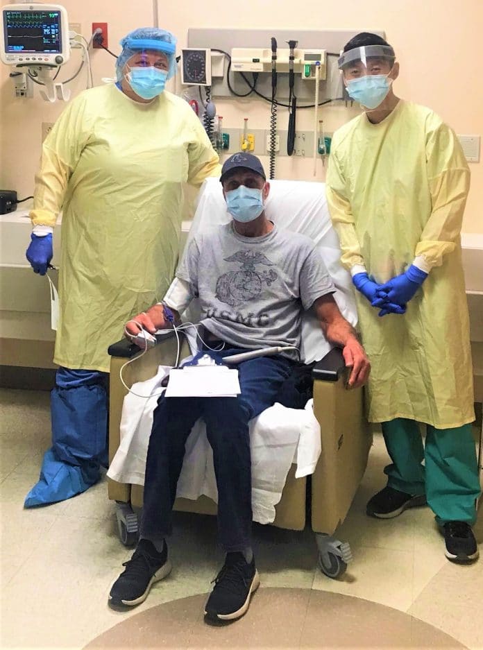 St. Petersburg General Hospital’s Kandice Williams, RN (right) and Vinson Huynh, M.D. (left) successfully performed HCA Healthcare West Florida’s first Monoclonal Antibody Therapy on patient Harry (center) on Wednesday, December 9 for the early treatment of COVID-19.  The outpatient IV treatment is approved by the FDA for patients at high risk to develop severe COVID-19.  Harry was visiting the area from Massachusetts when he developed symptoms and presented to Palms of Pasadena Hospital.  Harry was diagnos