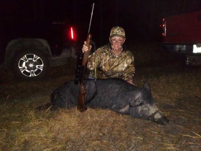 Toby's friend Shanna Marie Wofford and a big wild hog taken in spite of the cold and rains.