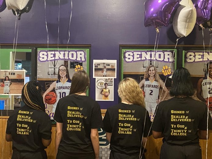 Signees with their Trinity College shirts.  Left to right: Calviona, Sabrina, Marissa, and Christiana