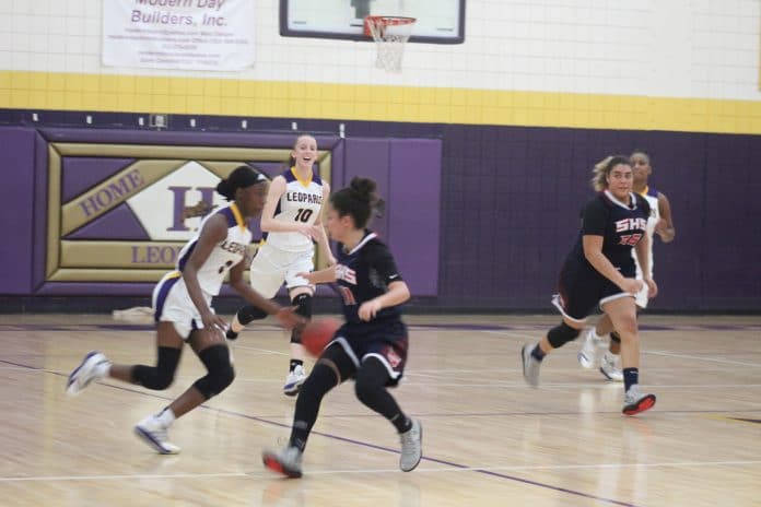 SHS #11 Samantha Suarez puts some pressure on HHS #0 Sy Crowley as she dribbles up the court.