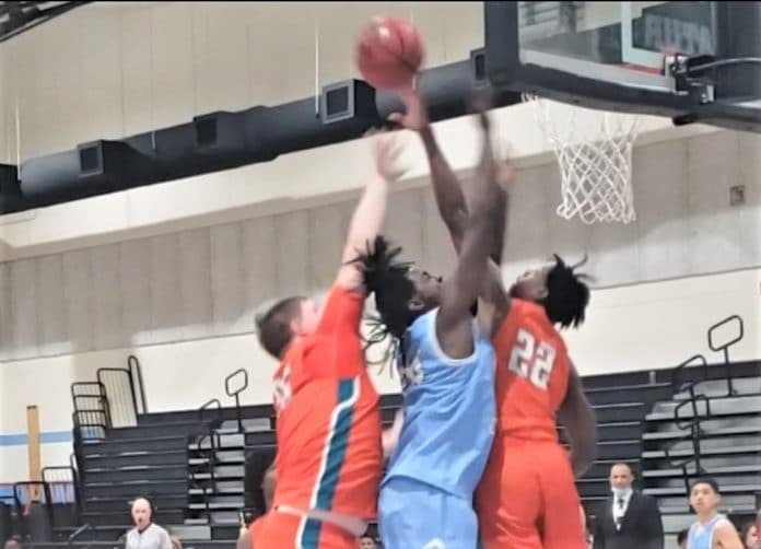 Nature Coast's Anthony Thrower Jr. rises up between Plant City's Andrew Walden and Ezereke Dawson