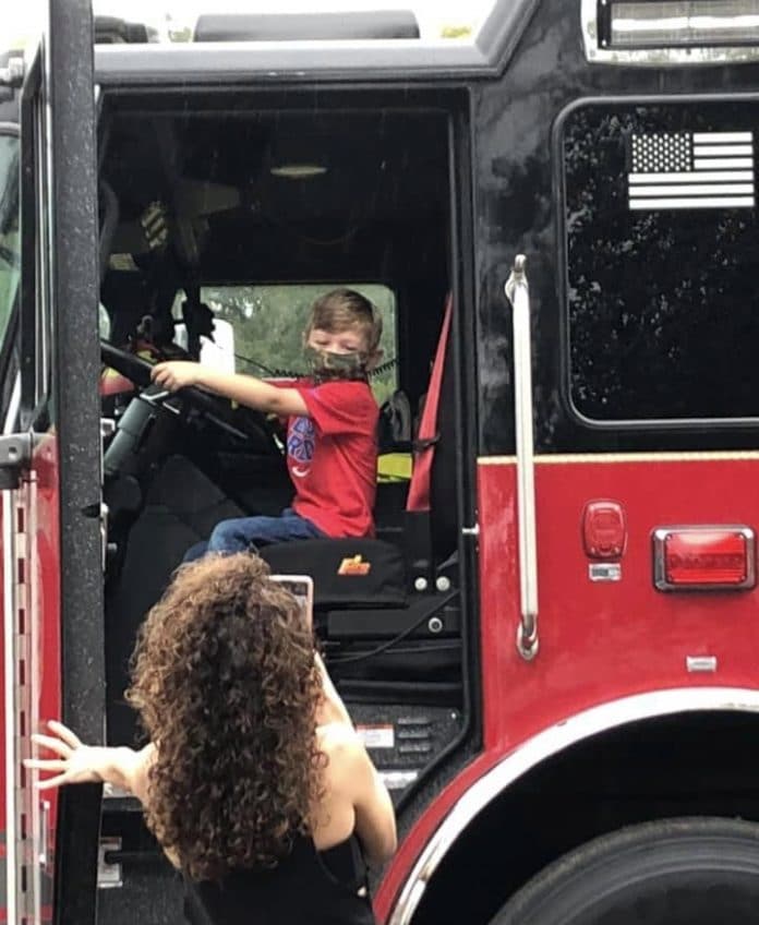 Boy sitting in firetruck