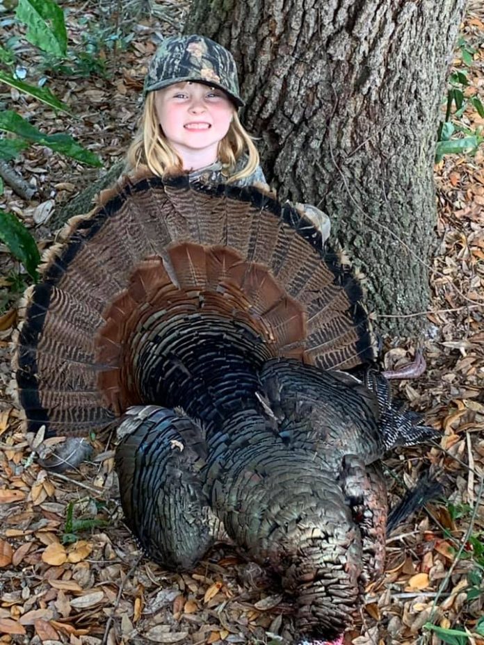 Little Payton Geer proudly displaying her first wild turkey, a true trophy gobbler!