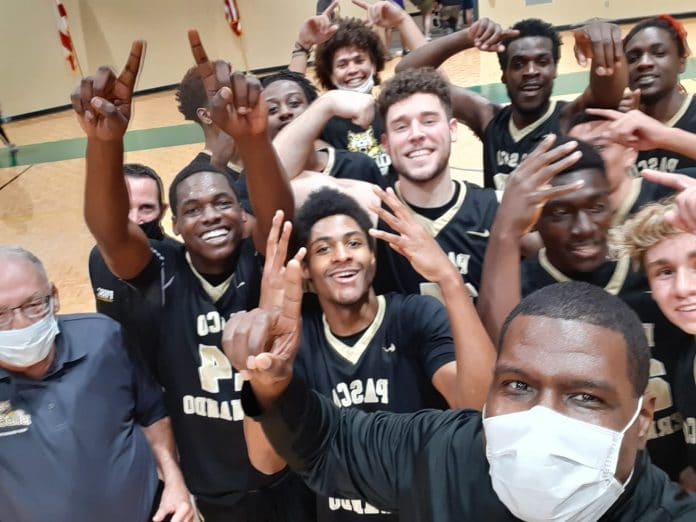 PHSC head basketball coach Micheal Jones with his team after winning the Div 8 championship.  Photo courtesy of Micheal Jones