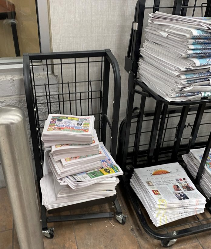 In this photo, the Hernando Sun rack is on the left.  There were so many free flyers placed on the rack that it collapsed both shelves.  Walmart on 19.