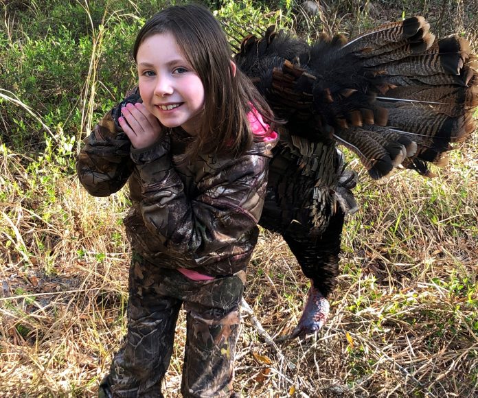 Miss Abbey Swick with her first gobbler after her daddy drove her all the way from Ohio for a morning's hunt with Toby.