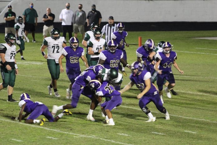 HHS defenders tackle a Weeki Wachee player last season.  Photo by Donna Garrett.