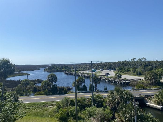 View of Jenkins Creek from overlook at Linda Peterson Park, you can see long fishing pier. Photo by Summer Hampton