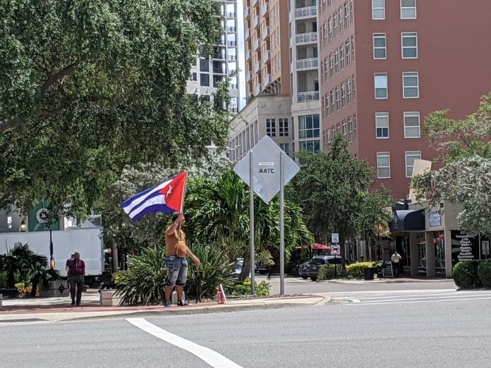 A man waves the Cuban flag in downtown Sarasota on Friday July 16, 2021. He told Hernando Sun that he attempted to escape Cuba by boat 13 times as a child and finally was granted political asylum in 1998.  He said that teenagers are being forced into the Cuban military and are killed if they do not obey orders.