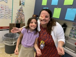 Colleen Fail clowning around with one of her students, Maya Jensen