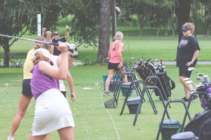 Hernando High girls golf coach Casey Ellis watches her golfer’s swing performance during practice at Brooksville Country Club on August 16.