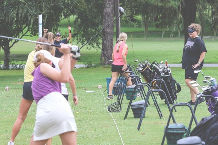 Hernando High girls golf coach Casey Ellis watches her golfer’s swing performance during practice at Brooksville Country Club on August 16. 