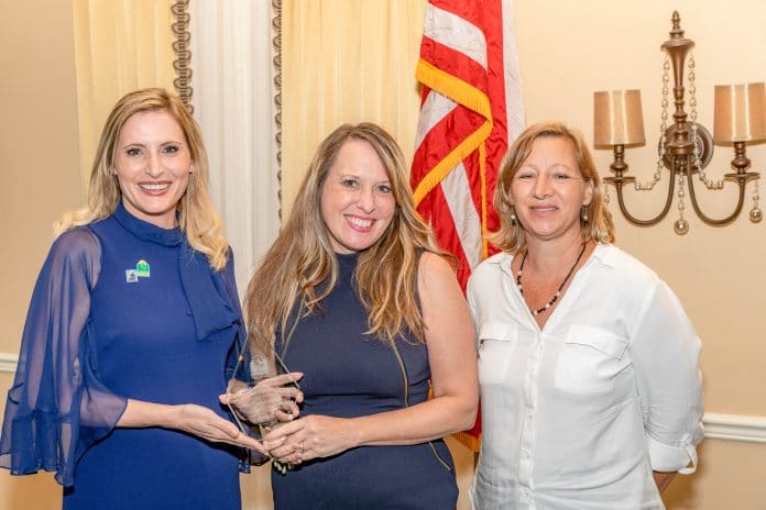 Brooksville Main Street's Natalie Kahler (center) and Jo-Anne Peck (right) receive the Public-Private Partnership Award from Florida's Secretary of State Laurel Lee (left).