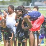 Troy Grant talks to one of the campers during the Tyrone Goodson Football Camp on Saturday, July 31, at Ernie Wever Youth Park in Brooksville.