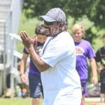 Dontae Roberts cheers on a camper after completing a performance drill during the Tyrone Goodson Football Camp at Ernie Wever Youth Park in Brooksville, Saturday, July 31st.