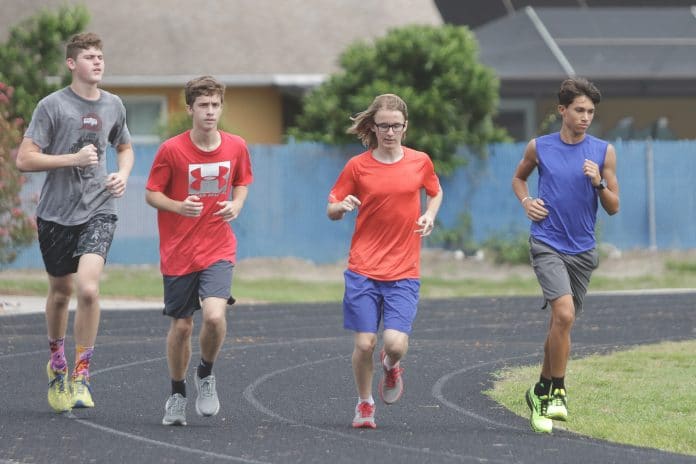 Isaac Rosario(right) and Andrew Brittain (second to the left) takes a practice lap with their teammates.