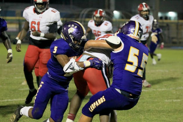 Kathleen's Jordan Gant is taken down by HHS's Jordan Williams and Anthony Talpa. Photo by Scott LaPrade