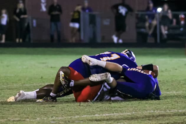 HHS Manny Acker and Chris Tolbert smother QB Shadarian Harrison from Kathleen. Photo Scott LaPrade