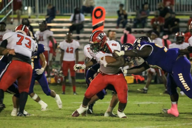 HHS Devin Williams gets his hand on QB Shadarian Harrison's jersey in attempt to stop him Photo Scott LaPrade